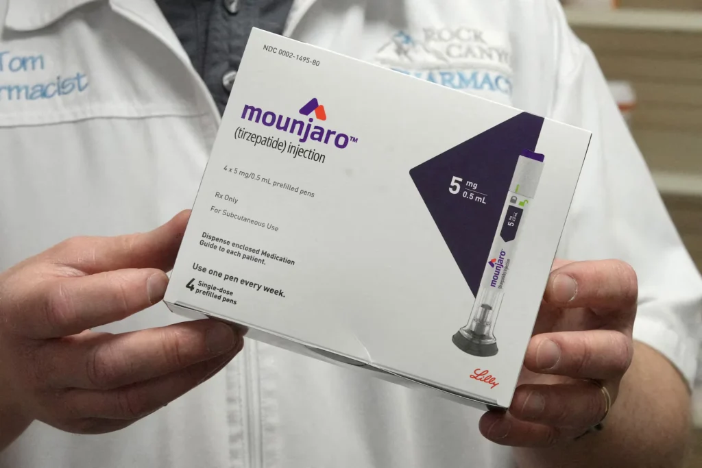 Yatton pharmacy pharmacist is holding a box of Mounjaro (tirzepatide) 5 mg injectable pens in yatton bristol.