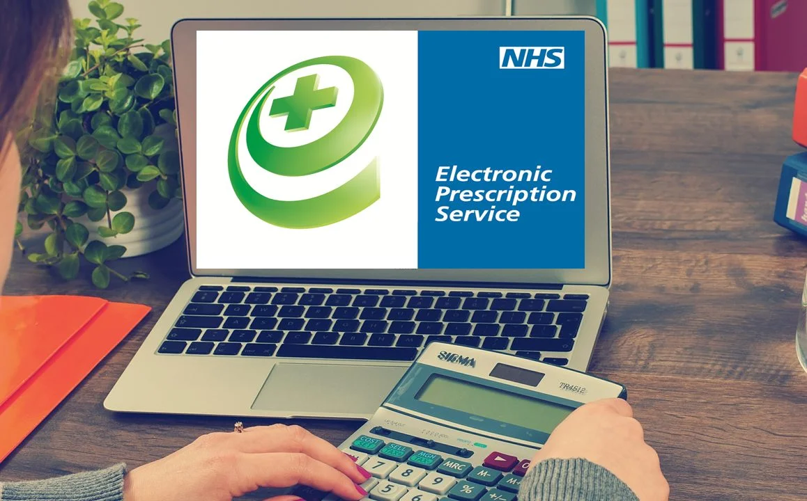 Person using laptop with NHS Electronic Prescription Service logo at Yatton Pharmacy in Yatton, Bristol