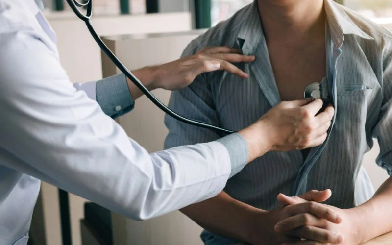 Healthcare professional using stethoscope for chest examination at Yatton Pharmacy in Yatton, Bristol