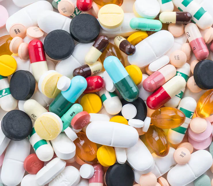 A colorful assortment of pills and capsules in various shapes, sizes, and colors is displayed.