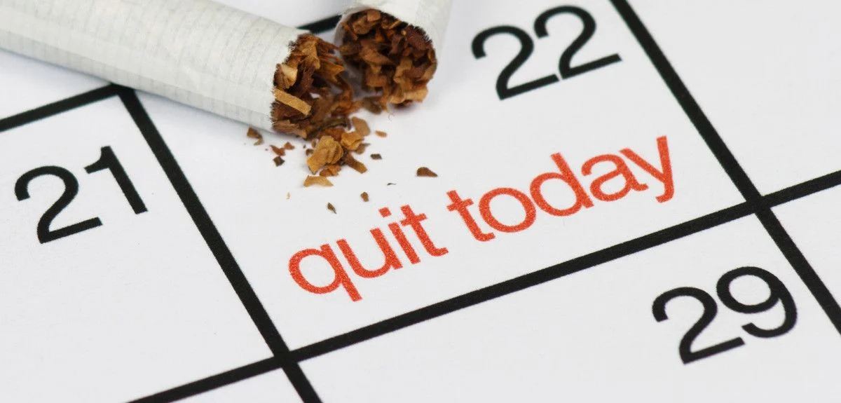 Broken cigarette on calendar marked “quit today” at Yatton Pharmacy in Yatton, Bristol